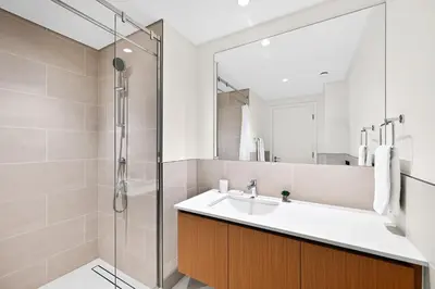 a bathroom with a sink and a shower at Modern 3BD with Maid's Room near Lagoon at Lotus 4 in Dubai