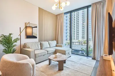 a living room with a couch and a chair at STAY BY LATINEM Luxury 1BR Holiday Home CC 0821 Near Downtown in Dubai