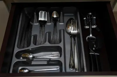 a tray with forks and spoons and silver utensils at Studio with Burj Khalifa view in Dubai