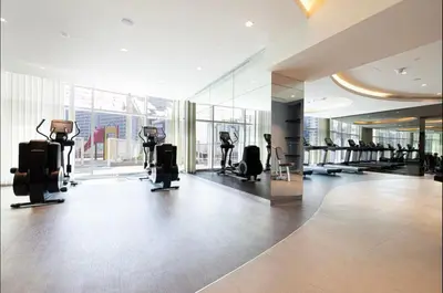 a gym with treadmills and ellipticals in a building at Studio with Burj Khalifa view in Dubai