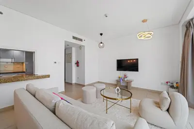 a living room with a couch and a table at Lux Retreat with Iconic Burj Khalifa Views in Dubai