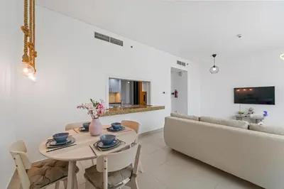 a living room with a table and a couch at Lux Retreat with Iconic Burj Khalifa Views in Dubai