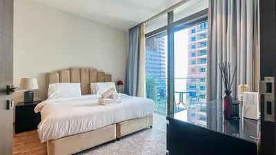 a bedroom with a bed and a large window at Exclusive 1BR in Marina Gate Dubai Marina - 46AB03 in Dubai