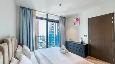 a bedroom with a large bed and a balcony at Exclusive 1BR in Marina Gate Dubai Marina - 46AB03 in Dubai