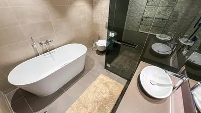 a bathroom with a tub and a toilet and a sink at Exclusive 1BR in Marina Gate Dubai Marina - 46AB03 in Dubai