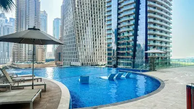 a large swimming pool in a city with tall buildings at Exclusive 1BR in Marina Gate Dubai Marina - 46AB03 in Dubai
