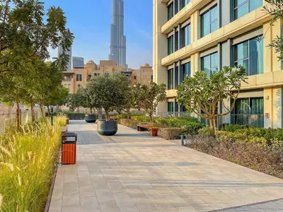 a sidewalk in front of a building with trees at Luxury 2BR with Burj Khalifa Views l Near Dubai Mall in Dubai