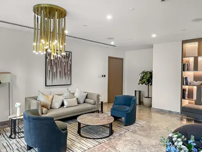 a living room with a couch and chairs and a chandelier at Luxury 2BR with Burj Khalifa Views l Near Dubai Mall in Dubai
