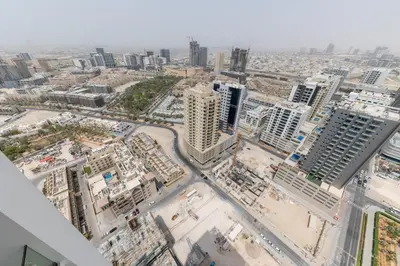 an aerial view of a city with tall buildings at Cozy Studio in JVC Dubai in Dubai