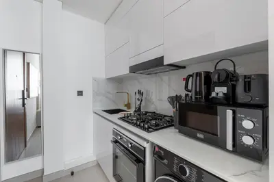 a kitchen with a stove and a microwave at Cozy Studio in JVC Dubai in Dubai