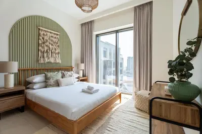 a bedroom with a bed and a large window at GuestReady - 2Bed l Lagoon Escape l Creek Beach in Dubai