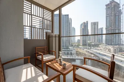 a room with a balcony with a view of a city at GuestReady - 2Bed l Lagoon Escape l Creek Beach in Dubai