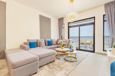 a living room with a couch and a table at Chic Apartment with Balcony & Views in Dubai