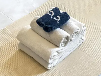 a pile of towels sitting on top of a table at Chic Apartment with Balcony & Views in Dubai
