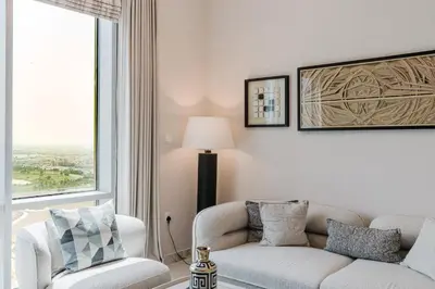 a living room with a couch and a chair at RH-Luxury 1BR Apt in Al Habtoor City with beautiful Canal View in Dubai
