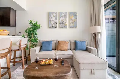 a living room with a couch and two glasses of wine at DAYF-MER Stylish 1Bed in central location Business Bay in Dubai