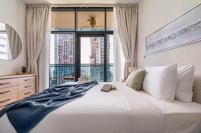 a bedroom with a large white bed and a window at DAYF-MER Stylish 1Bed in central location Business Bay in Dubai