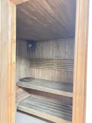 a wooden sauna with a bench in it at LYO guest house Dubai marina BEDSPACE in Dubai