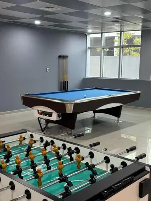 a billiard table in a room with a pool at LYO guest house Dubai marina BEDSPACE in Dubai