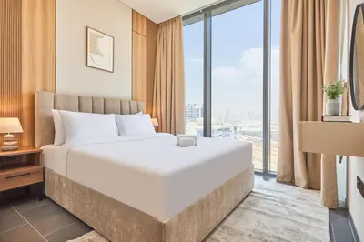 a bedroom with a large bed and a large window at STAY BY LATINEM Luxury 1BR Plus Study Holiday Home CB 1013 Near Burj Khalifa in Dubai