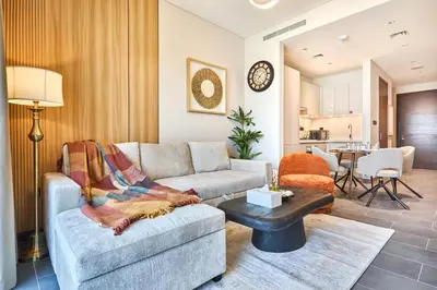 a living room with a couch and a table at STAY BY LATINEM Luxury 1BR Plus Study Holiday Home CB 1013 Near Burj Khalifa in Dubai