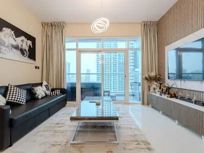 a living room with a black couch and a glass table at Continental Tower Stylish 2BR and Private Hot Tub in Dubai