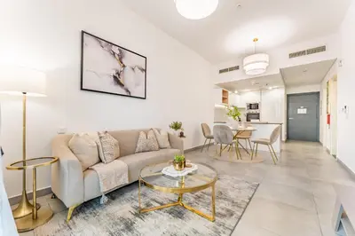 a living room with a couch and a table at Near Circle Mall And Parks, Easy Access to Al Khail Road And Close to RTA Bus Stop, Lucky Residences, JVC by Deluxe Holiday Homes in Dubai