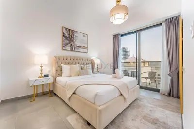 a bedroom with a bed and a large window at Near Circle Mall And Parks, Easy Access to Al Khail Road And Close to RTA Bus Stop, Lucky Residences, JVC by Deluxe Holiday Homes in Dubai