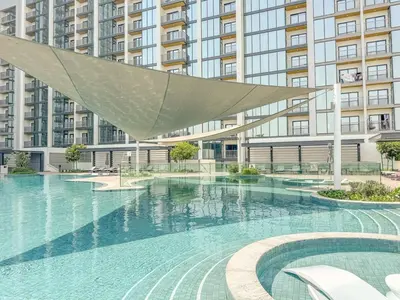 a large swimming pool in front of a large building at Modern 1BHK Bunk Beds and Sofa Bed By Czechin in Dubai