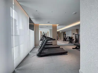 a gym with treadmills and elliptical machines at Modern 1BHK Bunk Beds and Sofa Bed By Czechin in Dubai