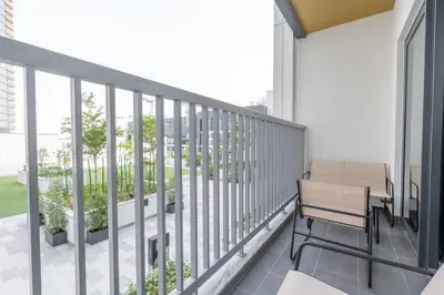 a balcony with a bench and some plants at Modern 1BHK Bunk Beds and Sofa Bed By Czechin in Dubai