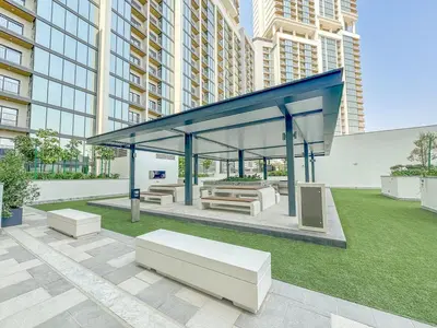 a gazebo with benches and tables in a city at Modern 1BHK Bunk Beds and Sofa Bed By Czechin in Dubai