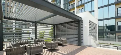 an outdoor patio with chairs and a building at Modern 1BHK Bunk Beds and Sofa Bed By Czechin in Dubai