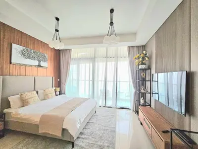 a bedroom with a large bed and a large window at Modern New Studio with Panoramic View in Business Bay in Dubai