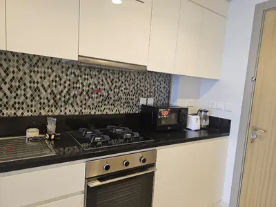 a kitchen with a stove and a counter top at Modern New Studio with Panoramic View in Business Bay in Dubai