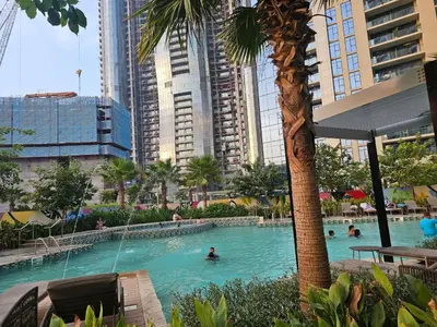 a pool in a city with people swimming in it at Modern New Studio with Panoramic View in Business Bay in Dubai