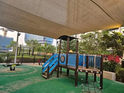a playground with a blue train in a park at Modern New Studio with Panoramic View in Business Bay in Dubai