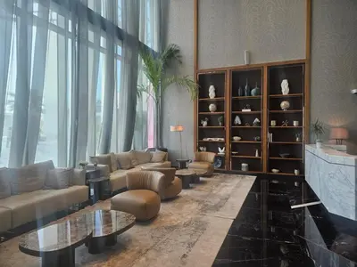 a living room with couches and tables and a large window at Modern New Studio with Panoramic View in Business Bay in Dubai