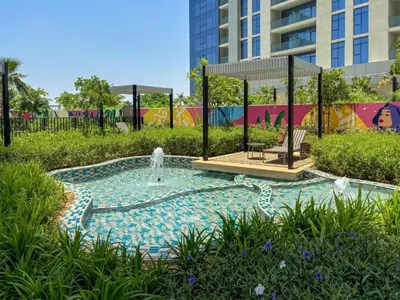 a swimming pool with a fountain in a park at Modern New Studio with Panoramic View in Business Bay in Dubai