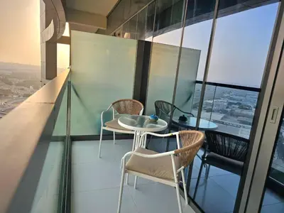 a balcony with chairs and a table on a building at Modern New Studio with Panoramic View in Business Bay in Dubai