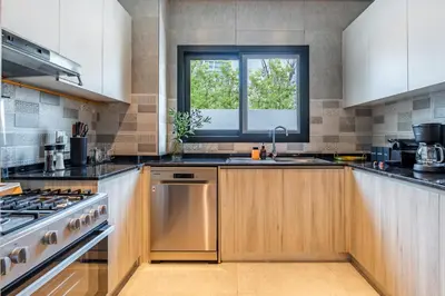 a kitchen with a sink and a stove and a window at Private Pool Paradise Villa! Dubai Mall in a Flash! Complimentary Full Mid-Stay Refresh for 1 week stay in Dubai