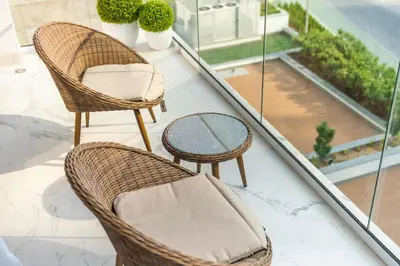 two chairs and a table on a balcony at AirDXB - Meydan Apartment sleeps 4 in Great Location in Dubai