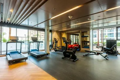 a gym with treadmills and exercise equipment in a building at AirDXB - Meydan Apartment sleeps 4 in Great Location in Dubai