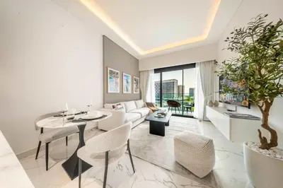 a living room with a couch and a table and chairs at AirDXB - Meydan Apartment sleeps 4 in Great Location in Dubai
