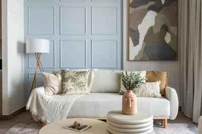 a living room with a couch and a table at GuestReady - Creek View l 2Bed l Lagoon Escape in Dubai