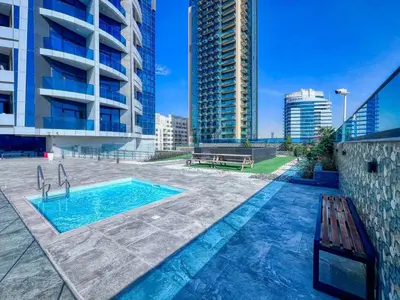 a swimming pool in the middle of a building at GuestReady - Stylish l High Floor Studio in Dubai