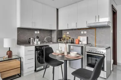 a kitchen with a table and chairs in it at GuestReady - Stylish l High Floor Studio in Dubai