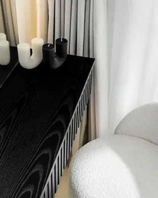 a room with a chair and a table with curtains at Waves - Luxury Beachfront Escape - Skyline & Sea Views in Dubai