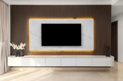 a living room with a tv on a wall at Waves - Luxury Beachfront Escape - Skyline & Sea Views in Dubai