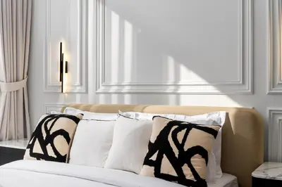 a bed with black and white pillows in a room at Waves - Luxury Beachfront Escape - Skyline & Sea Views in Dubai